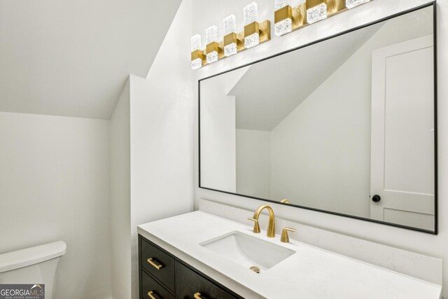 2611 Charlesgate Ave, Decatur, GA 30030 - bathroom featuring toilet, vanity, and lofted ceiling