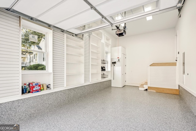 2611 Charlesgate Ave, Decatur, GA 30030 - garage featuring a garage door opener and baseboards