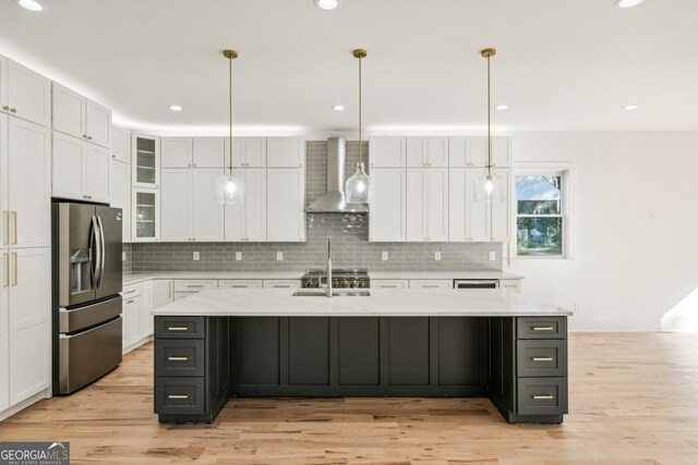 2611 Charlesgate Ave, Decatur, GA 30030 - kitchen with stainless steel fridge with ice dispenser, wall chimney range hood, white cabinetry, light wood-type flooring, and recessed lighting