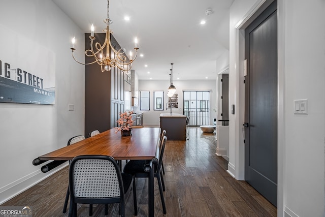 dining area featuring dark wood finished floors, an inviting chandelier, baseboards, and recessed lighting