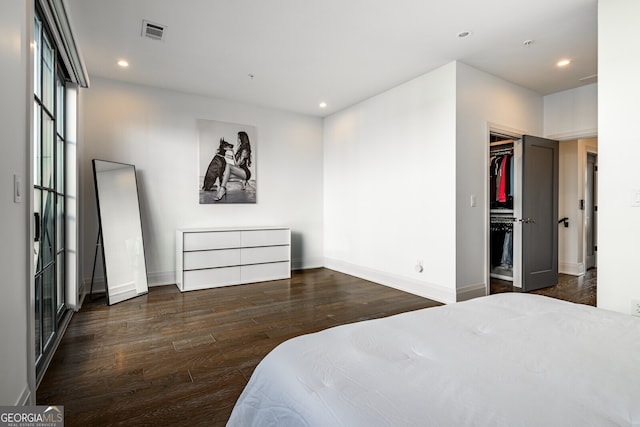 bedroom featuring baseboards, wood finished floors, visible vents, and recessed lighting