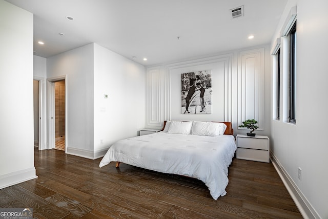 bedroom featuring wood finished floors, visible vents, and recessed lighting
