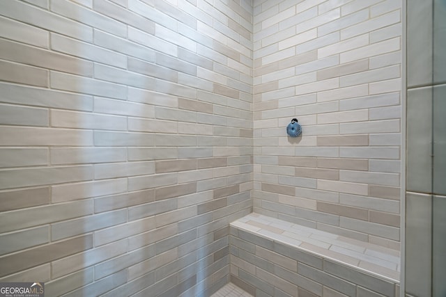 bathroom with a tile shower