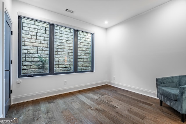 interior space featuring dark wood-style floors, baseboards, visible vents, and recessed lighting