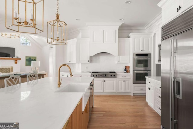 kitchen with white cabinetry, stainless steel appliances, and light countertops