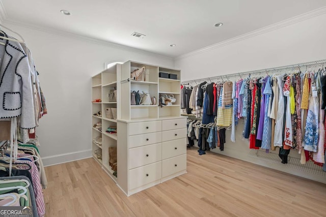 spacious closet featuring visible vents and light wood-type flooring