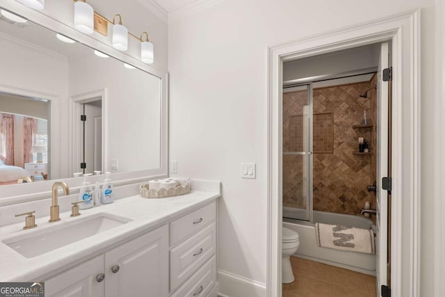 bathroom featuring toilet, shower / bath combination with glass door, crown molding, tile patterned flooring, and vanity