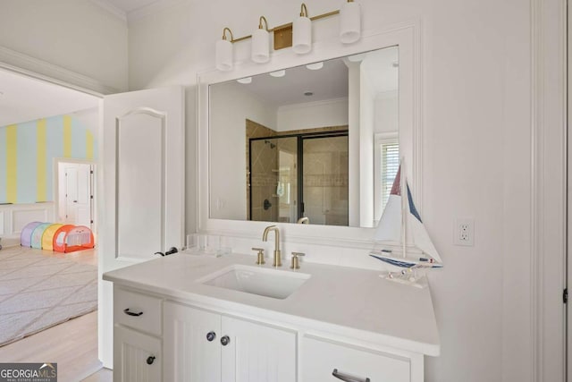 full bathroom with a shower stall, vanity, and ornamental molding