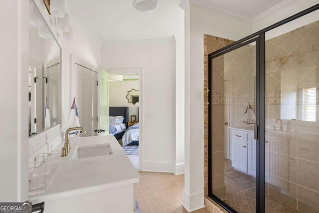 ensuite bathroom featuring vanity, ensuite bath, ornamental molding, tile patterned flooring, and a shower stall