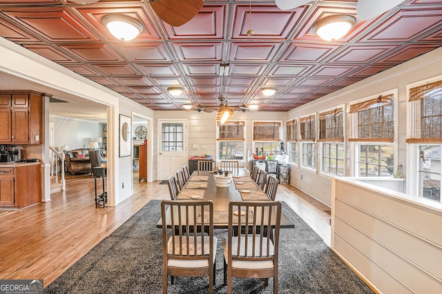 dining area featuring an ornate ceiling and light wood-style flooring