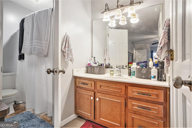 bathroom featuring toilet and vanity