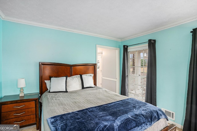 bedroom featuring visible vents, a textured ceiling, and ornamental molding