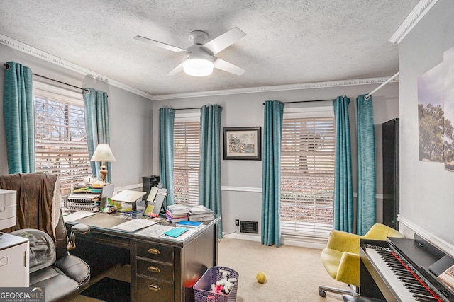 home office with crown molding, carpet flooring, visible vents, and ceiling fan