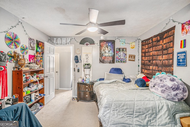 carpeted bedroom with a textured ceiling and ceiling fan