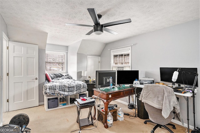 office featuring a textured ceiling, ceiling fan, and carpet floors