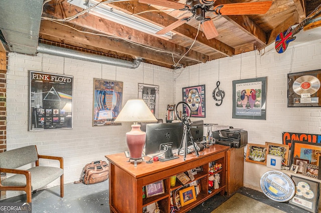 office space featuring beam ceiling, brick wall, concrete flooring, and a ceiling fan