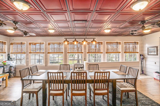 dining room with an ornate ceiling, light wood-type flooring, and ceiling fan