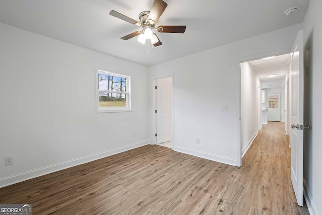 unfurnished bedroom featuring a ceiling fan, baseboards, and wood finished floors