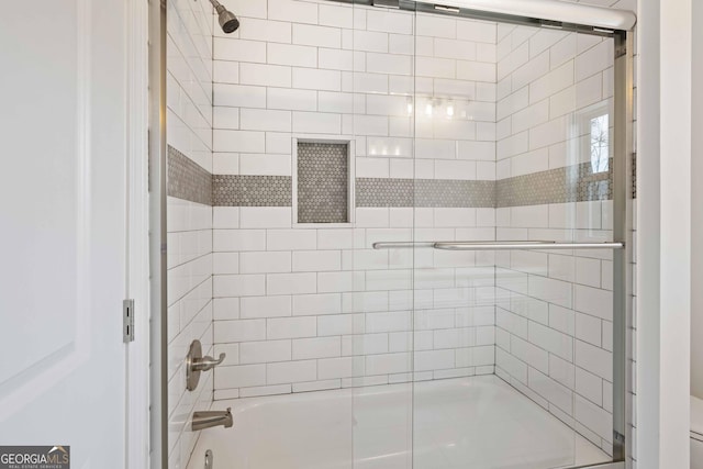 full bathroom with bath / shower combo with glass door