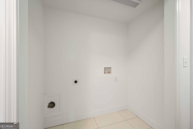 clothes washing area with baseboards, light tile patterned floors, laundry area, hookup for a washing machine, and hookup for an electric dryer