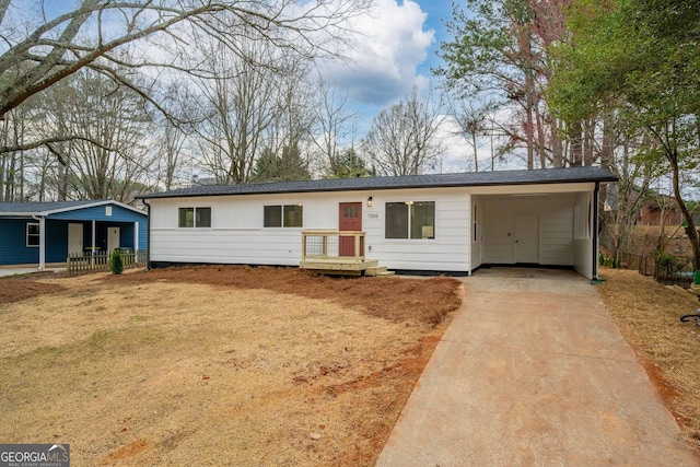 single story home with an attached carport and driveway