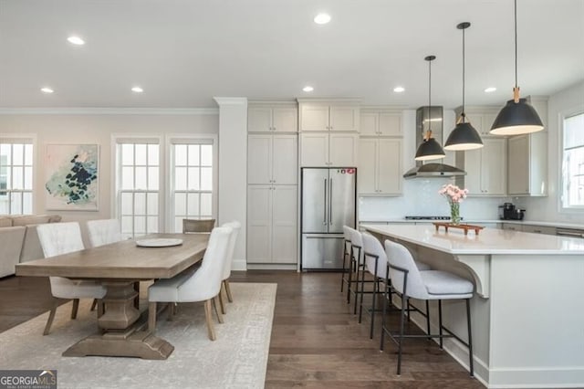 385 Rowes Cir, Alpharetta, GA 30009 - kitchen with high quality fridge, wall chimney range hood, ornamental molding, light countertops, and hanging light fixtures