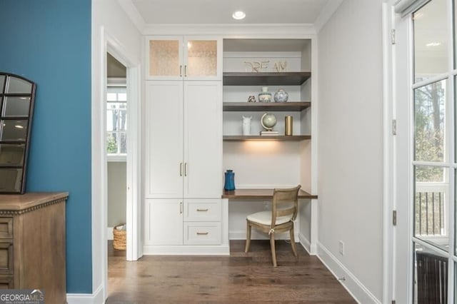 385 Rowes Cir, Alpharetta, GA 30009 - home office featuring built in desk, dark wood finished floors, baseboards, plenty of natural light, and ornamental molding