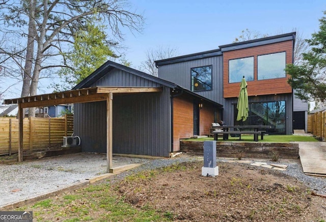 rear view of house featuring fence