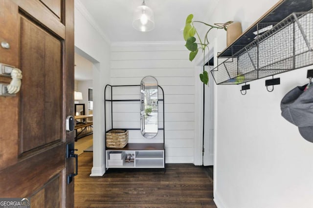 interior space with baseboards, dark wood-type flooring, and ornamental molding