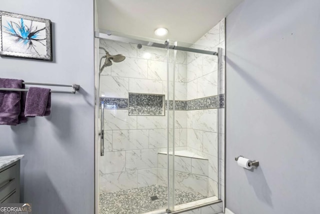 bathroom with a stall shower and vanity