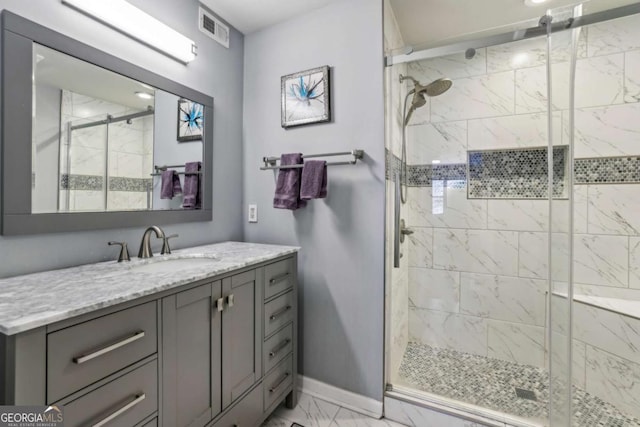 full bathroom with vanity, a shower stall, marble finish floor, baseboards, and visible vents