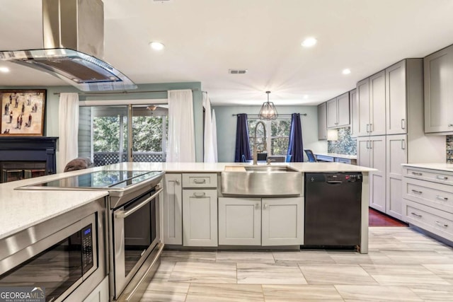 kitchen featuring gray cabinets, a sink, stainless steel appliances, island range hood, and light countertops