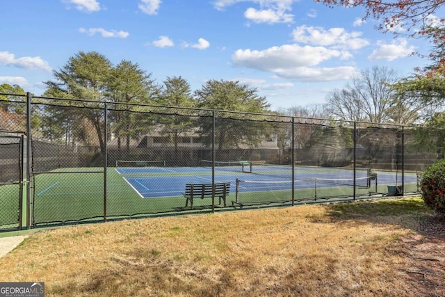 view of tennis court with fence