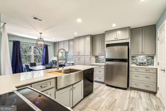 kitchen featuring gray cabinetry, visible vents, black dishwasher, and freestanding refrigerator