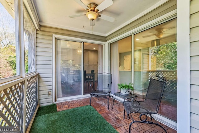 sunroom / solarium with a ceiling fan