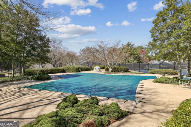view of swimming pool featuring a fenced in pool, fence, and a patio area
