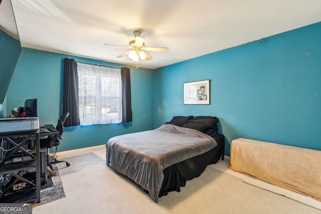 carpeted bedroom featuring ceiling fan and baseboards