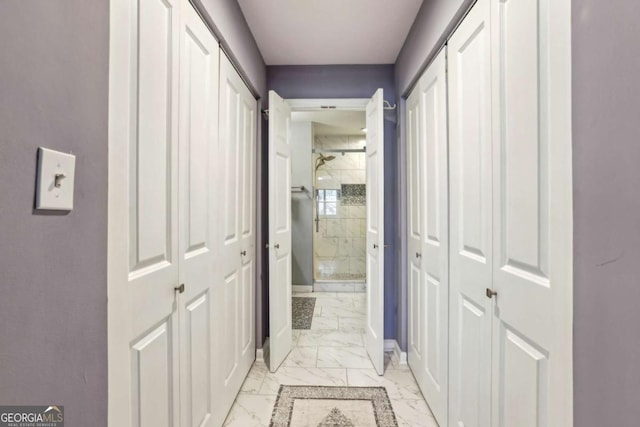 hall featuring marble finish floor and baseboards