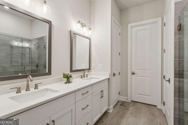 full bathroom with a sink, double vanity, and a shower stall