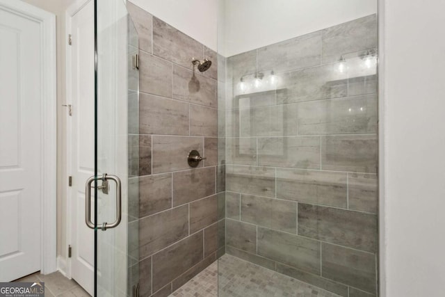 bathroom with tile patterned floors and a stall shower