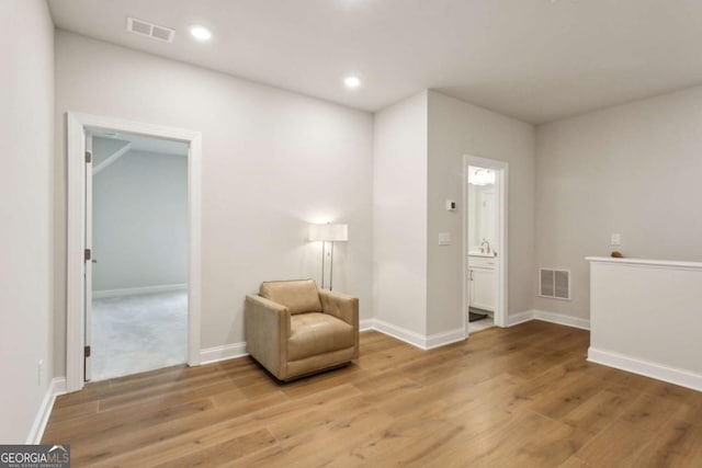 sitting room with recessed lighting, visible vents, and light wood-style flooring