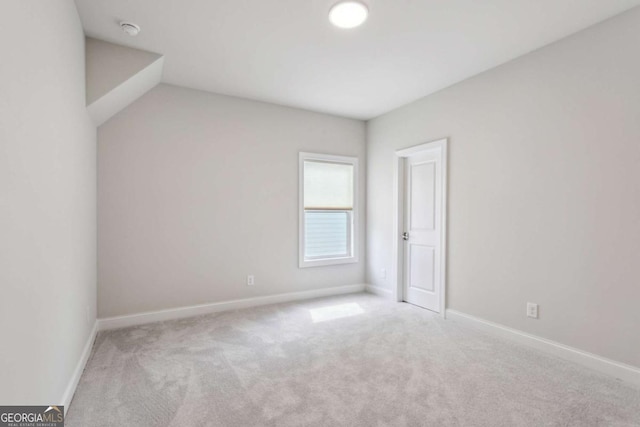 carpeted empty room with baseboards