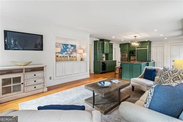 living area featuring wine cooler, recessed lighting, and light wood-type flooring