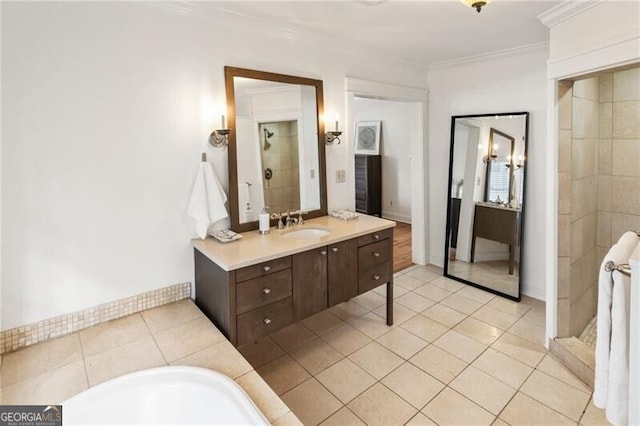 full bath with vanity, baseboards, tiled shower, tile patterned flooring, and crown molding