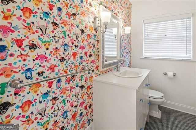 bathroom featuring tile patterned flooring, toilet, vanity, and baseboards