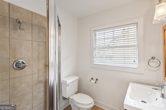 full bath with vanity, a shower stall, toilet, and baseboards