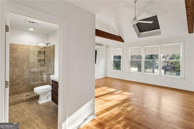 interior space with plenty of natural light, vaulted ceiling with beams, ceiling fan, and wood finished floors