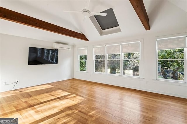 unfurnished living room with lofted ceiling with beams, wood finished floors, baseboards, and a wall mounted air conditioner