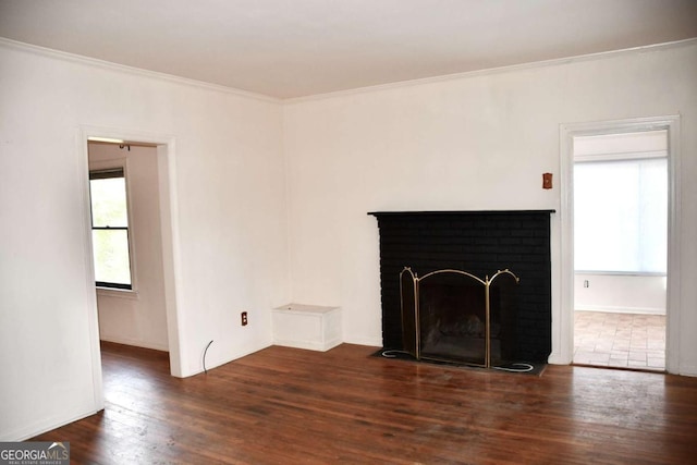 unfurnished living room with a fireplace, wood finished floors, a wealth of natural light, and ornamental molding