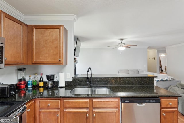 kitchen with a sink, dark stone counters, a peninsula, appliances with stainless steel finishes, and ceiling fan